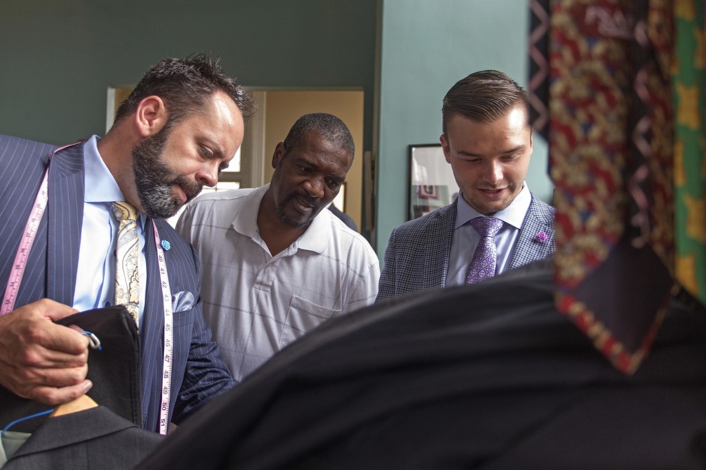 Chris and Seth Schafer help Kevin Tyson, 50, find a tie to match his suit.