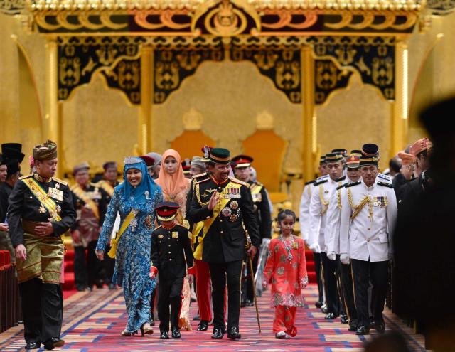 Bruneiís Sultan Hassanal Bolkiah and members of the royal family leave the throne room after his 67th birthday celebrations at Nurul Iman Palace in Bandar Seri Begawan