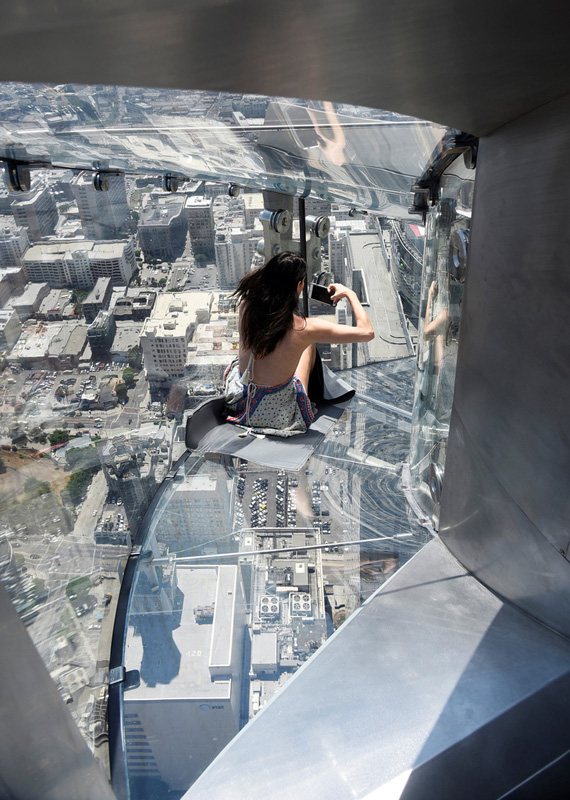 A member of the media rides the Skyslide from the 70th to 69th floor of the U.S. Bank Tower in Los Angeles, California