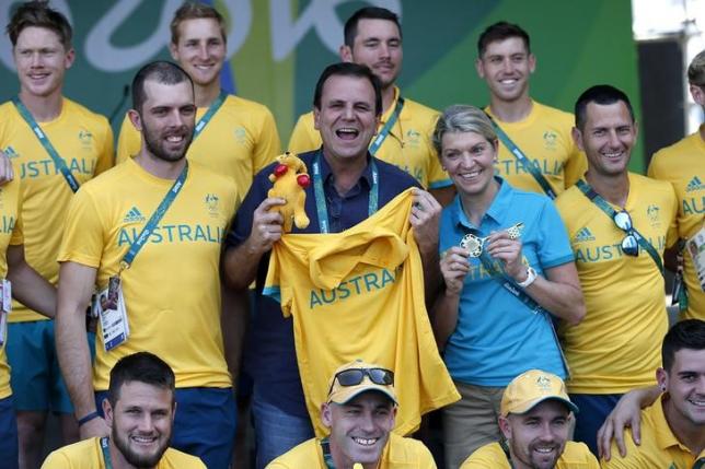 Rio's mayor Paes and Chiller, Chef de Mission for Australia, pose for a photo next to members of the Australian delegation in Rio de Janeiro