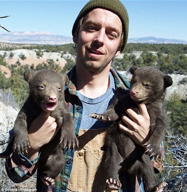 3661E9FB00000578-3695921-He_shows_his_caring_side_as_he_poses_with_two_cubs_which_he_has_-a-2_1468914049676