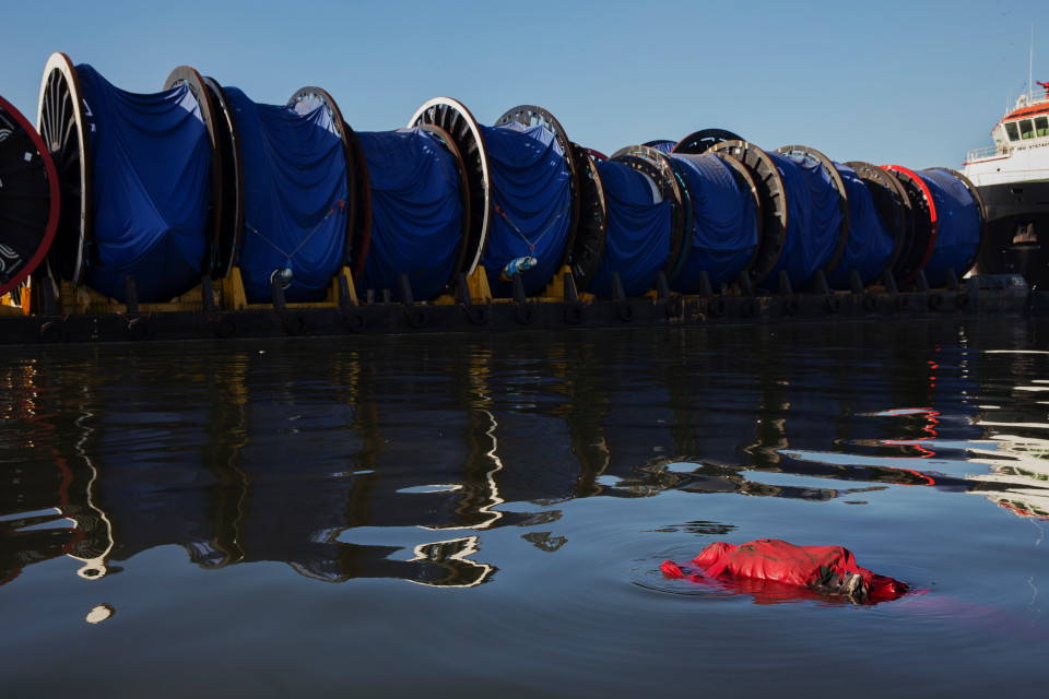 A body floats in the waters of Guanabara bay, a sailing venue for the 2016 Olympics, in Rio de Janeiro.