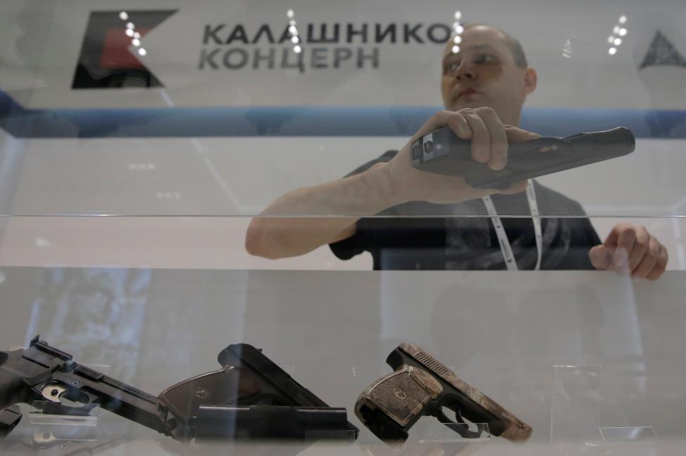 Salesperson holds model gun at gunmaker Kalashnikov's newly opened souvenir store in Moscow's Sheremetyevo airport