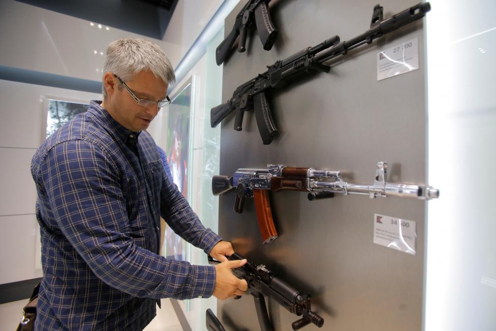 A man browses a model of the Vityaz submachine gun at the newly opened Gunmaker Kalashnikov souvenir store in Moscow's Sheremetyevo airport