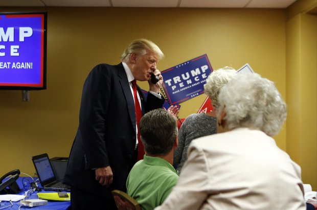 ASHEVILLE, NC - SEPTEMBER 12: Republican presidential candidate Donald Trump speaks to a caller on the other end of the phone line as volunteers man a phone bank prior to a rally on September 12, 2016 at U.S. Cellular Center in Asheville, North Carolina. Trump continues to campaign for his run for president of the United States.(Photo by Brian Blanco/Getty Images)