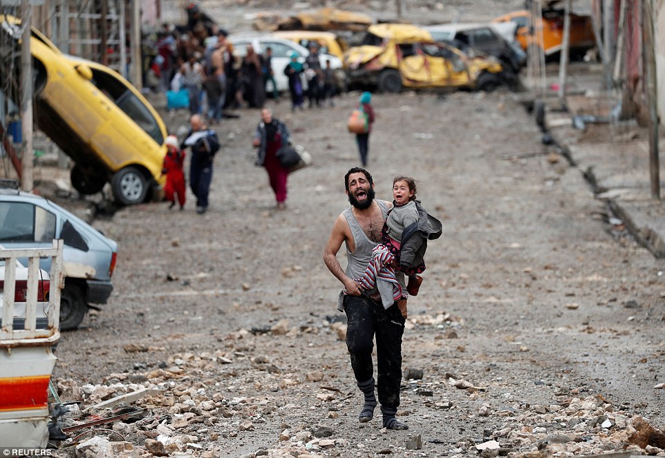 3DF8B04500000578-4285270-A_man_weeps_as_he_carries_his_daughter_to_safety_from_an_ISIS_he-a-167_1488792108615