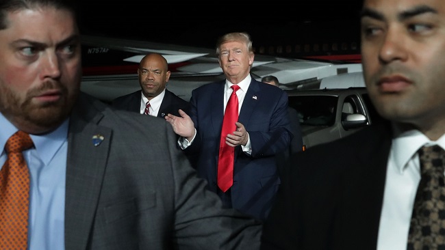 ALBUQUERQUE, NM - OCTOBER 30: Surrounded by U.S. Secret Service agents, Republican presidential nominee Donald Trump (C) arrives for a campaign rally at Atlantic Aviation near Albuquerque International Airport October 30, 2016 in Albuquerque, New Mexico. With less than nine days until Americans go to the polls, Trump is campaigning in Nevada, New Mexico and Colorado. (Photo by Chip Somodevilla/Getty Images)