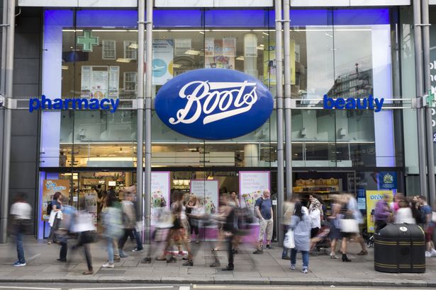 Members-of-the-public-walk-past-a-branch-of-Boots-the-chemist-on-Oxford-Street