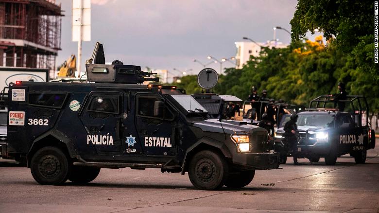 EDITORS NOTE: Graphic content / Mexican police patrol in a street of Culiacan, state of Sinaloa, Mexico, on October 17, 2019, after heavily armed gunmen in four-by-four trucks fought an intense battle with Mexican security forces. - Mexican security forces on Thursday arrested one son of jailed drug kingpin Joaquin "El Chapo" Guzman in an operation that triggered fighting in the western city of Culiacan, Security Minister Alfonso Durazo said. (Photo by RASHIDE FRIAS / AFP) (Photo by RASHIDE FRIAS/AFP via Getty Images)