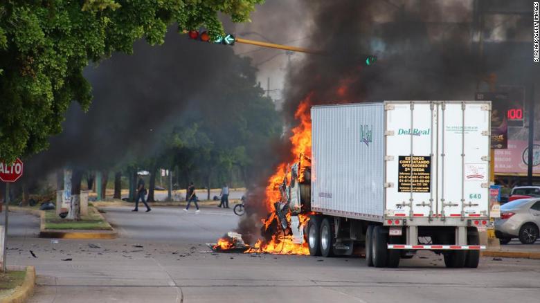 A truck burns in a street of Culiacan, state of Sinaloa, Mexico, on October 17, 2019. - Heavily armed gunmen in four-by-four trucks fought an intense battle against Mexican security forces Thursday in the city of Culiacan, capital of jailed kingpin Joaquin "El Chapo" Guzman's home state of Sinaloa. (Photo by STR / AFP) (Photo by STR/AFP via Getty Images)