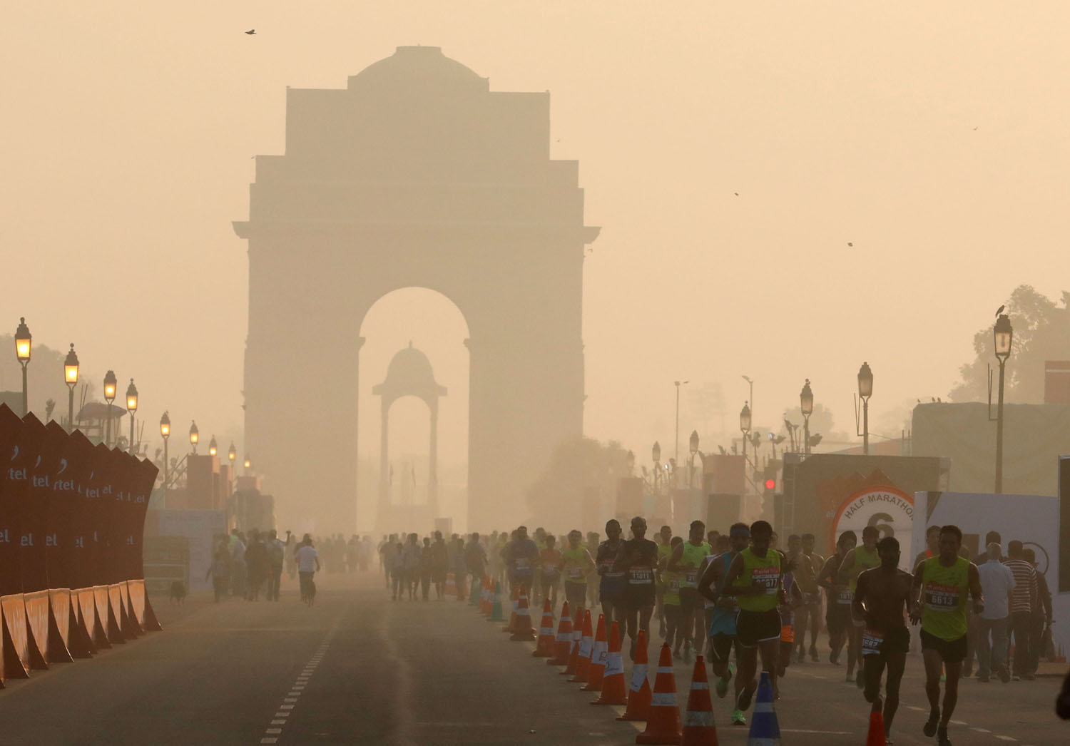 Participants run past the India Gate as they take part in the Airtel Delhi Half Marathon in New Delhi