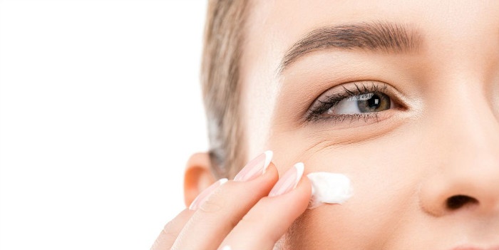 cropped-view-of-young-woman-applying-cosmetic-cream-royalty-free-image-916516526-1551975562.jpg