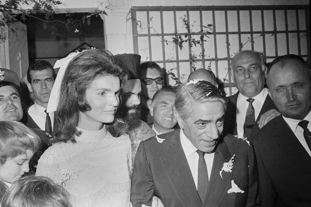 Jacqueline Kennedy and Aristotle Onassis are shown following their wedding in Skorpios, Greece, Oct. 20, 1968. Caroline Kennedy can be seen at far left. (AP Photo)