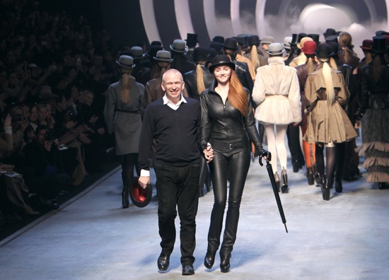 French designer Jean Paul Gaultier (L, front) walks with British model Lily Cole as he acknowledges the public after the Hermes autumn-winter 2010/2011 ready-to-wear collection show on March 10, 2010 in Paris. AFP PHOTO/Pierre Verdy (Photo credit should read PIERRE VERDY/AFP/Getty Images)