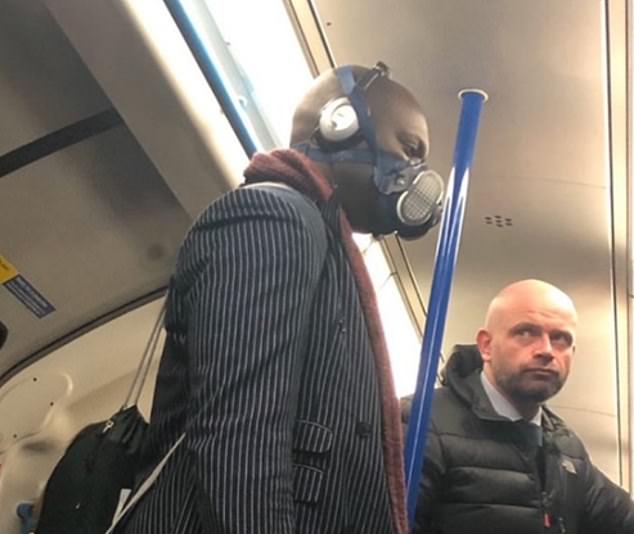 24702998-8001853-A_tube_goer_wears_a_face_mask_on_a_London_underground_train_It_i-m-1_1581664353639
