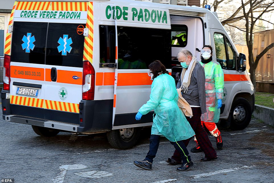25057932-8031839-Health_workers_and_a_patient_are_seen_outside_a_hospital_in_Padu-a-5_1582395190285