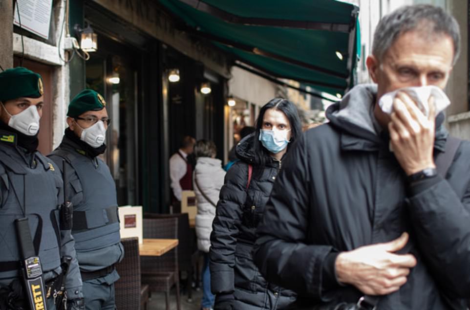 25088708-8034547-Tourists_walk_round_Venice_wearing_face_masks_after_the_announce-a-51_1582501797011