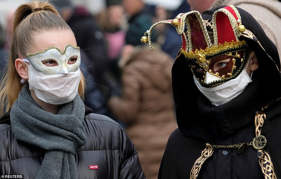 25092378-8034547-Masked_carnival_revellers_wear_protective_face_masks_at_Venice_C-a-44_1582501796786