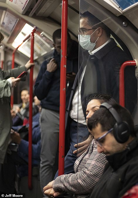 25281956-8055813-A_commuter_wearing_a_face_mask_on_the_central_line_tube_in_Londo-a-6_1582905695565