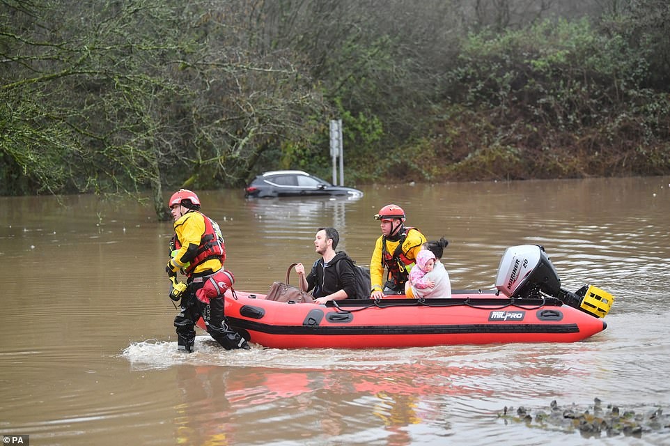 24799852-8010579-Rescue_workers_save_a_woman_and_a_baby_as_they_evacuate_resident-a-358_1581891127335.jpg