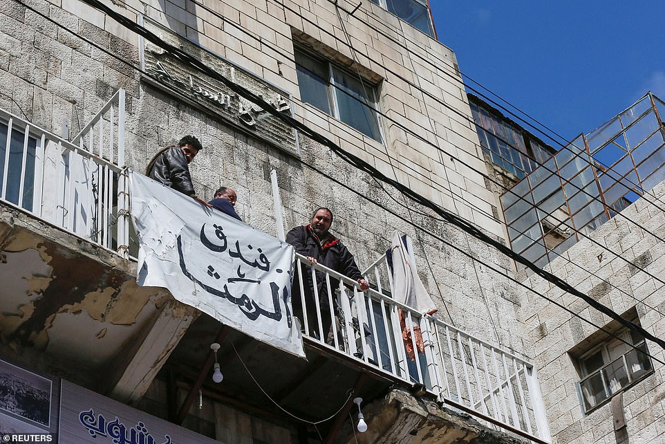 26241236-8137963-People_look_from_the_balcony_of_a_hotel_after_the_start_of_a_nat-a-36_1584804966981