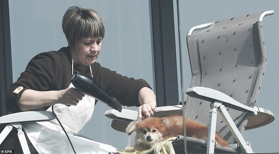 26241240-8137963-A_woman_dries_her_dog_s_coat_on_the_balcony_of_her_home_during_t-a-29_1584804966852