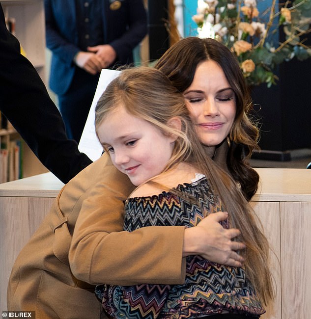 21616176-7738765-Princess_Sofia_of_Sweden_stopped_to_hug_a_young_girl_as_she_atte-m-7_1575041874667