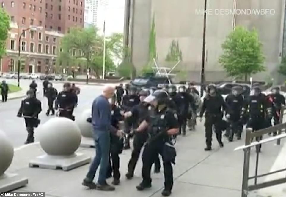 29250582-8390857-An_elderly_man_was_seen_approaching_Buffalo_police_officers_in_r-a-1_1591358082010