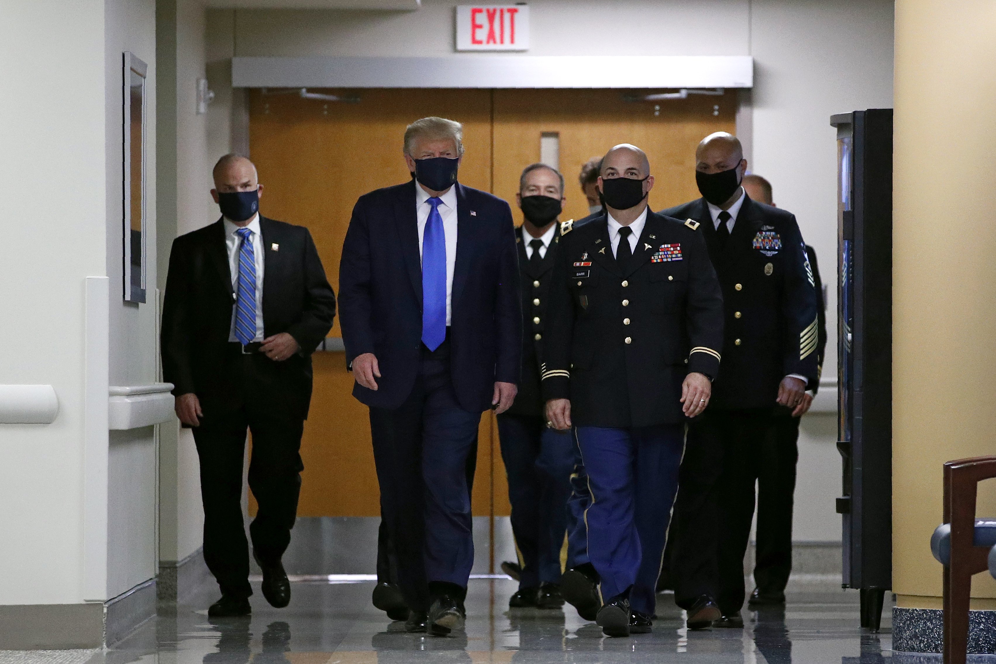 President Donald Trump wears a face mask as he walks down a hallway during a visit to Walter Reed National Military Medical Center in Bethesda, Md., Saturday, July 11, 2020. (AP Photo/Patrick Semansky)