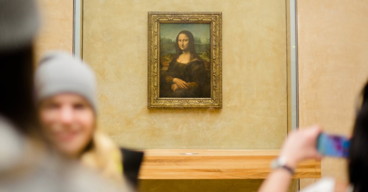 PARIS, FRANCE - FEBRUARY 28: Visitors take pictures of Leonardo da Vinci 'Mona Lisa' inside the Louvre museum on February 28, 2014 in Paris, France. The museum is housed in the Louvre Palace, one of the world's largest museums which opened 1793. (Photo by Christian Marquardt/Getty Images)