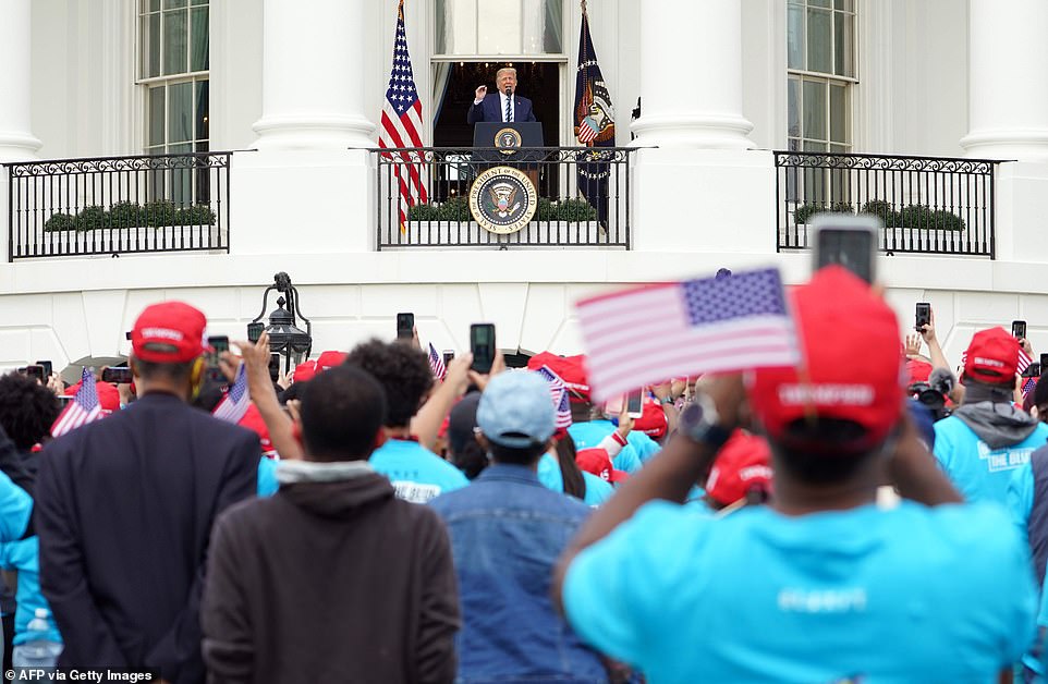 34233892-8826761-Trump_walked_out_onto_the_White_House_balcony_to_the_crowd_of_ar-a-188_1602366539820